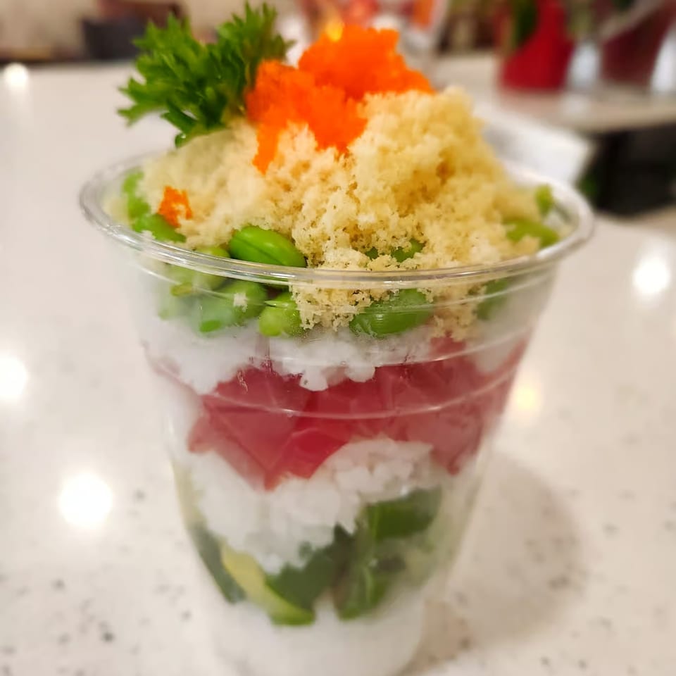Honey's Bie Thai & Sushi's layered poke cup with tuna, rice, edamame, avocado, and roe.